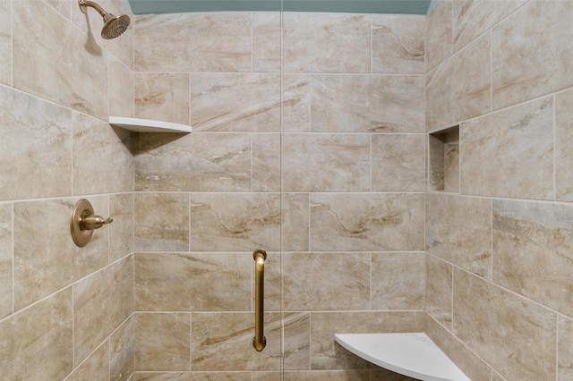 bathroom with a tile shower