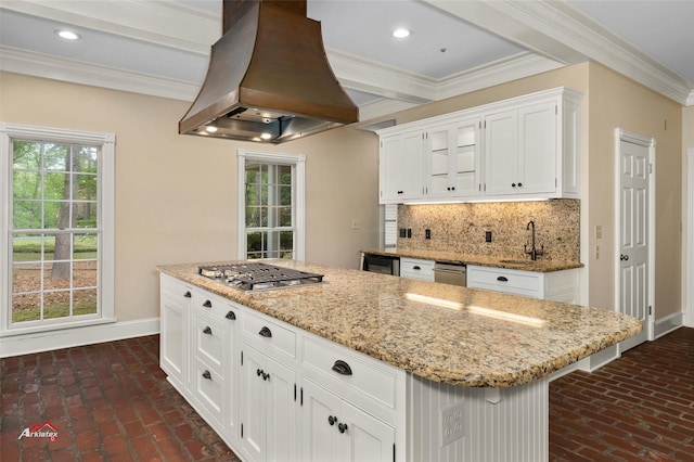 kitchen with a center island, island exhaust hood, tasteful backsplash, white cabinetry, and appliances with stainless steel finishes