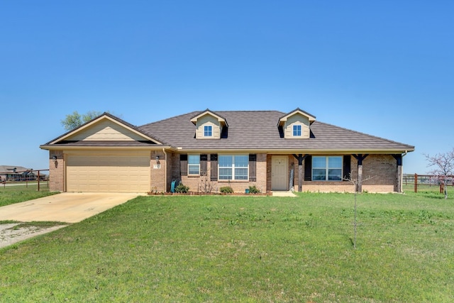 view of front of home featuring a front yard and a garage