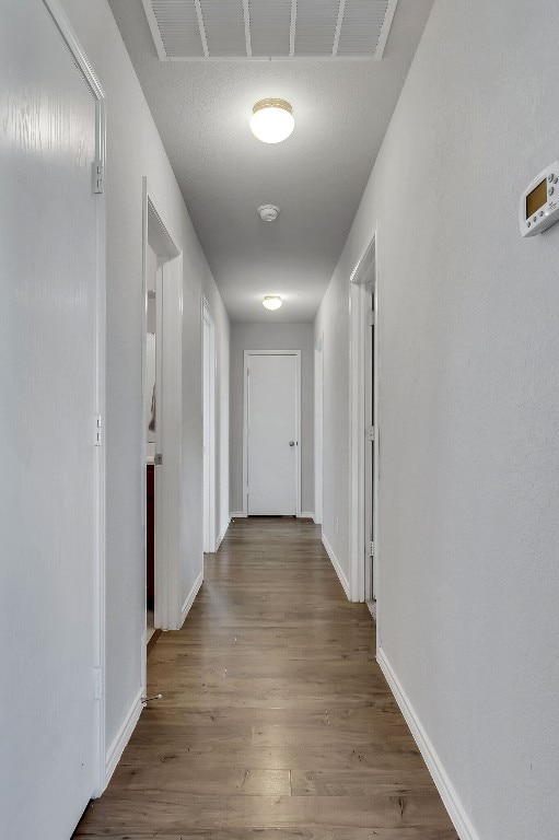 hallway with dark wood-type flooring