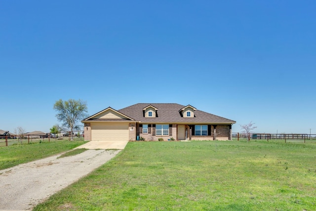 view of front of property featuring a front yard and a garage