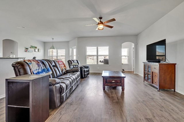 living room featuring dark hardwood / wood-style flooring and ceiling fan