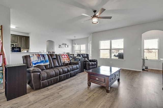 living room featuring ceiling fan and light hardwood / wood-style floors