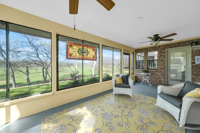 sunroom / solarium with a healthy amount of sunlight and ceiling fan