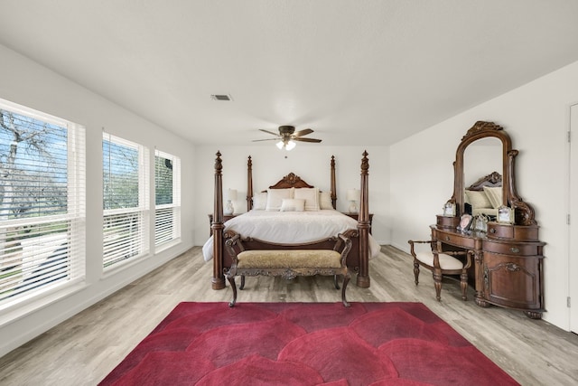 bedroom with light hardwood / wood-style floors and ceiling fan