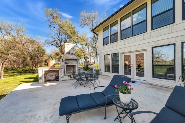 view of patio featuring an outdoor stone fireplace