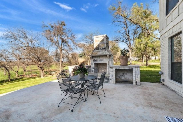 view of patio with an outdoor stone fireplace