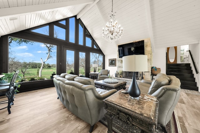 living room featuring an inviting chandelier, high vaulted ceiling, light hardwood / wood-style floors, and beamed ceiling