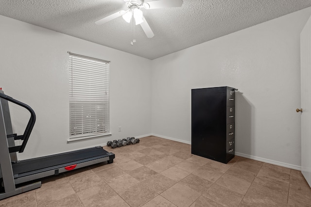 workout room with light tile patterned flooring, a textured ceiling, and ceiling fan