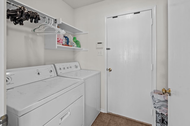 laundry room featuring washing machine and dryer and light tile patterned flooring