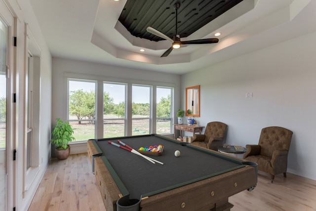 playroom featuring ceiling fan, light hardwood / wood-style flooring, a raised ceiling, and pool table