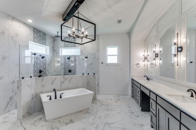 bathroom featuring independent shower and bath, vanity, and a chandelier