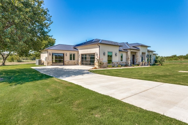 view of front of house featuring cooling unit and a front lawn