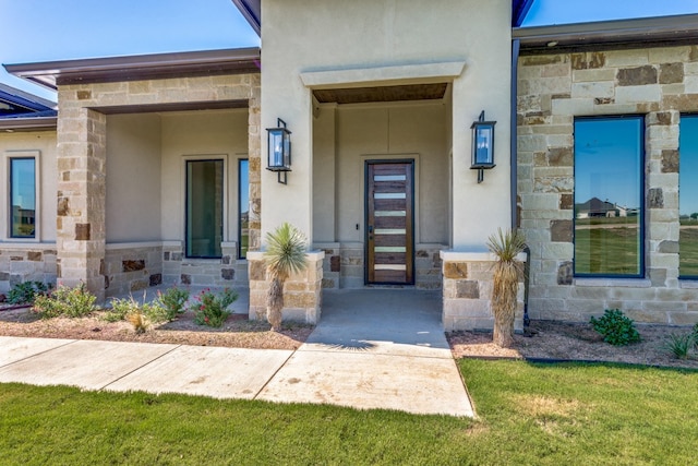 property entrance with a yard