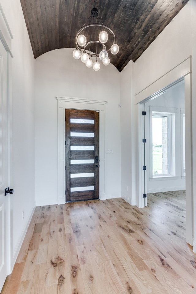 foyer featuring wood ceiling, lofted ceiling, light hardwood / wood-style floors, and a chandelier