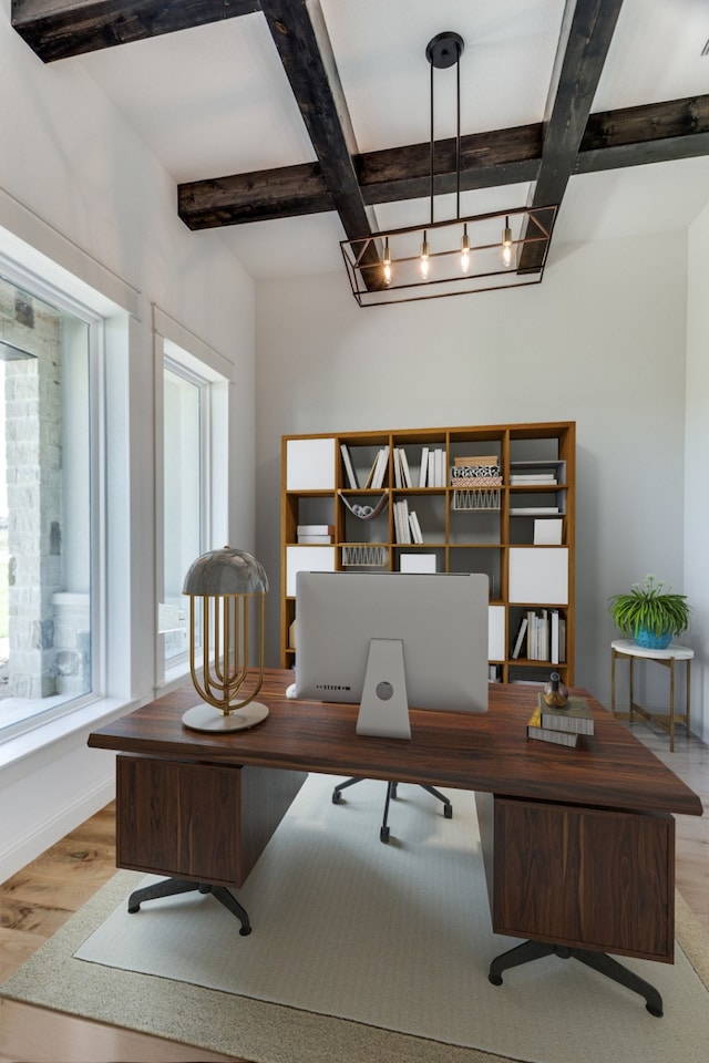 office space featuring light wood-type flooring, coffered ceiling, and beam ceiling