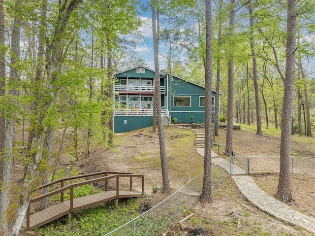 rear view of property featuring a deck