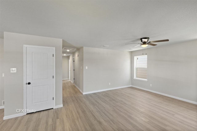 empty room featuring ceiling fan and light wood-type flooring