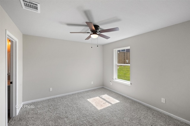 carpeted spare room with ceiling fan