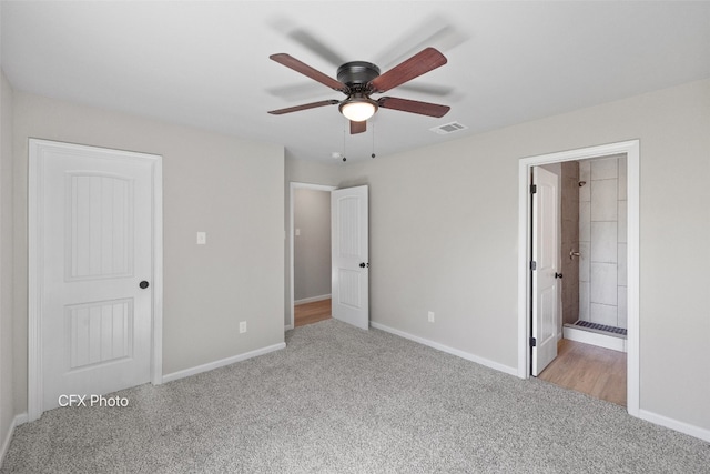 unfurnished bedroom with ceiling fan, light carpet, and ensuite bathroom