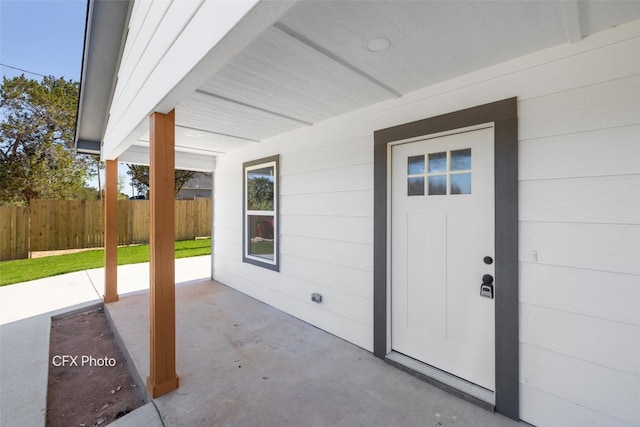 view of exterior entry featuring a patio area