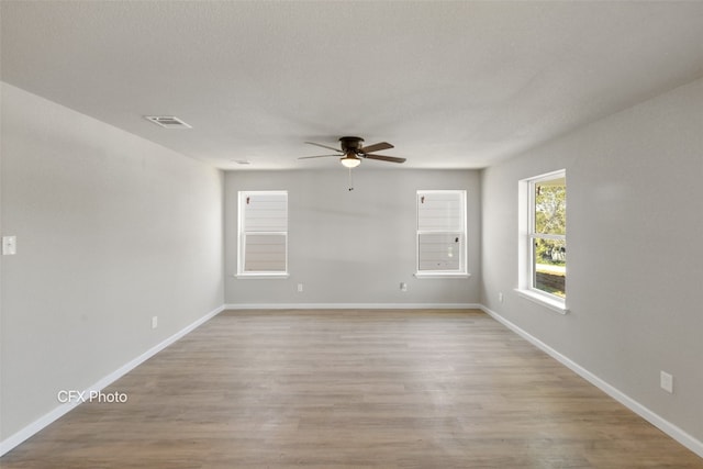 empty room featuring ceiling fan and light hardwood / wood-style flooring