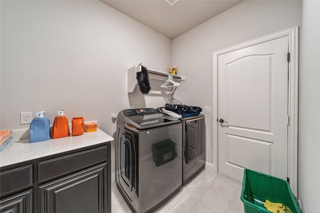 washroom with light tile flooring, cabinets, and separate washer and dryer