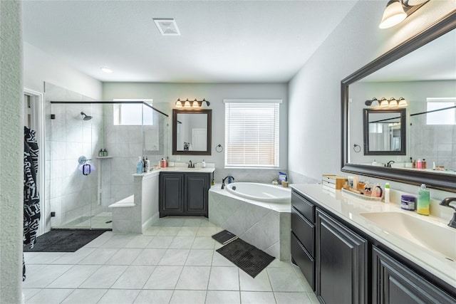 bathroom with shower with separate bathtub, tile floors, and vanity