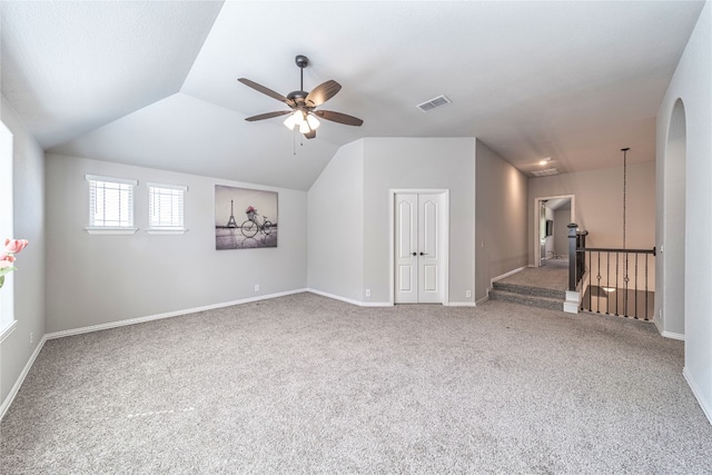 additional living space featuring lofted ceiling, light carpet, and ceiling fan