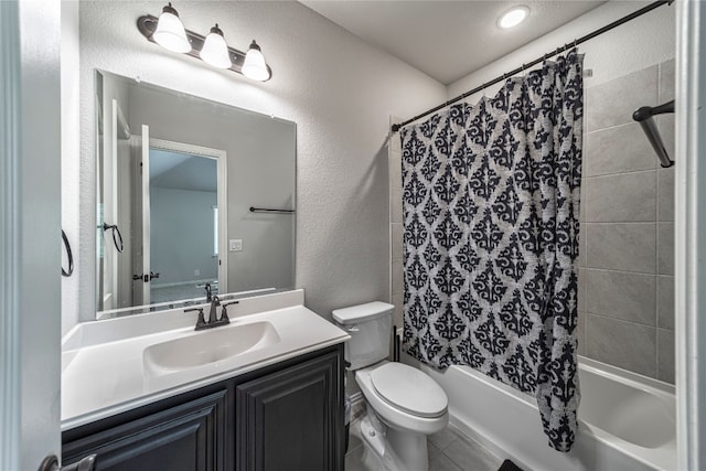 full bathroom featuring shower / bath combo with shower curtain, toilet, tile flooring, and vanity