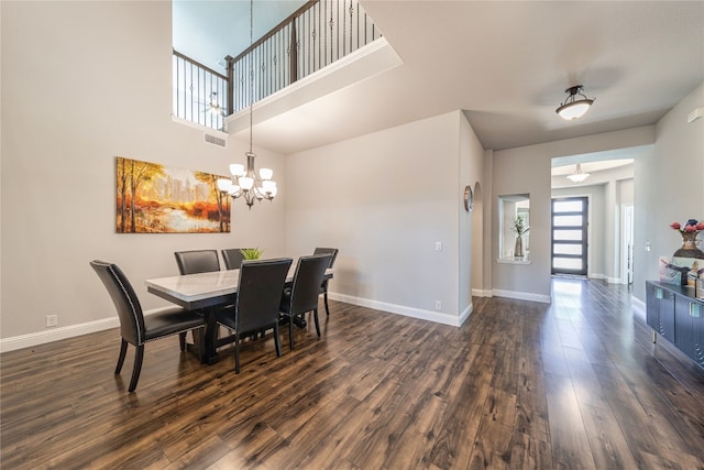 dining space with a chandelier, a high ceiling, and dark hardwood / wood-style floors