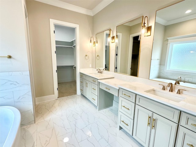 bathroom featuring vanity, ornamental molding, and a bathing tub