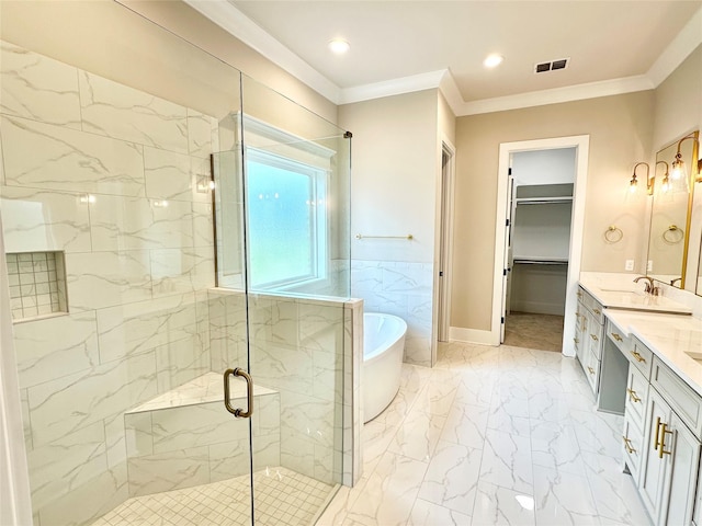 bathroom featuring ornamental molding, separate shower and tub, and vanity