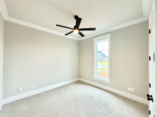 unfurnished room with crown molding, light colored carpet, and ceiling fan