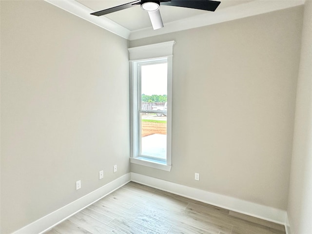 spare room with ornamental molding, ceiling fan, and light hardwood / wood-style flooring