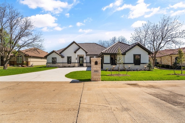 mediterranean / spanish-style house with a front lawn