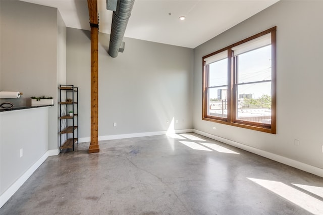 spare room with concrete flooring