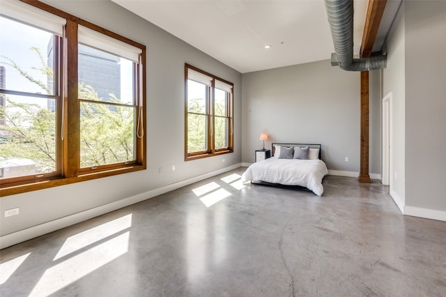 bedroom featuring concrete flooring