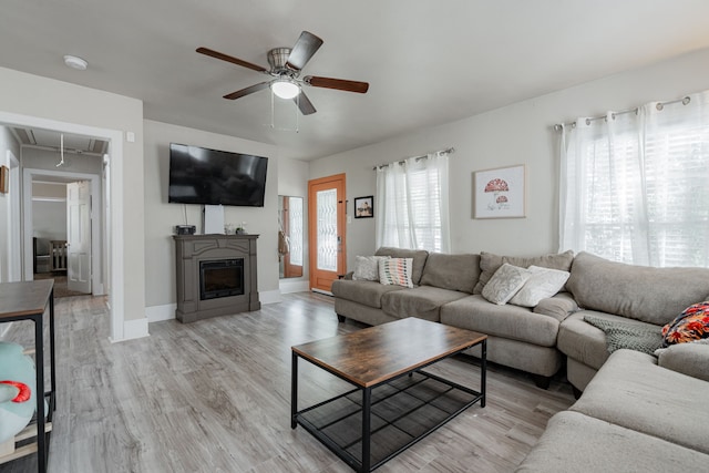 living room with light wood-type flooring and ceiling fan