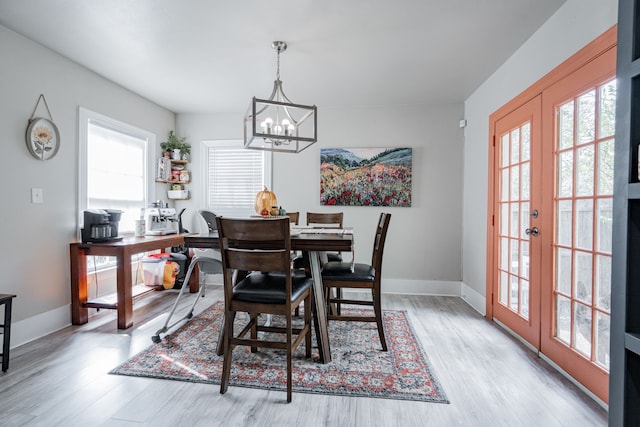 dining area with french doors, light wood-type flooring, and a healthy amount of sunlight