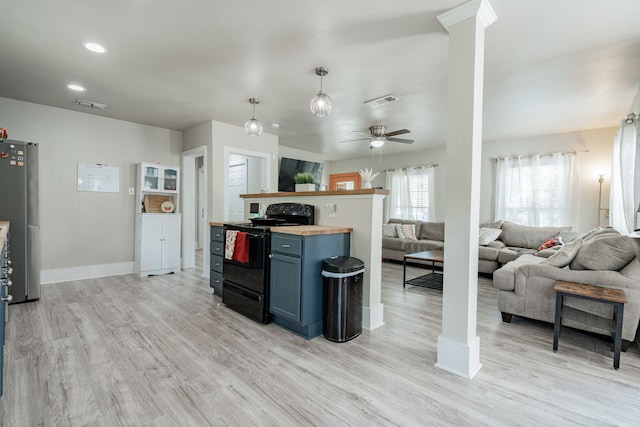 kitchen with light hardwood / wood-style flooring, hanging light fixtures, stainless steel fridge, black / electric stove, and ceiling fan