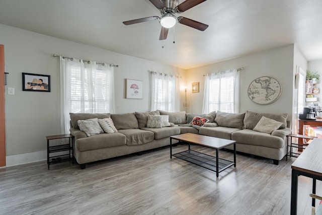 living room featuring light hardwood / wood-style floors and ceiling fan