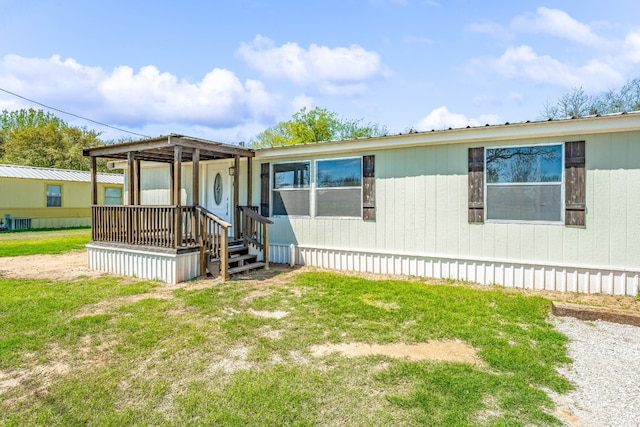 view of front of house with a pergola, a front yard, and central AC unit