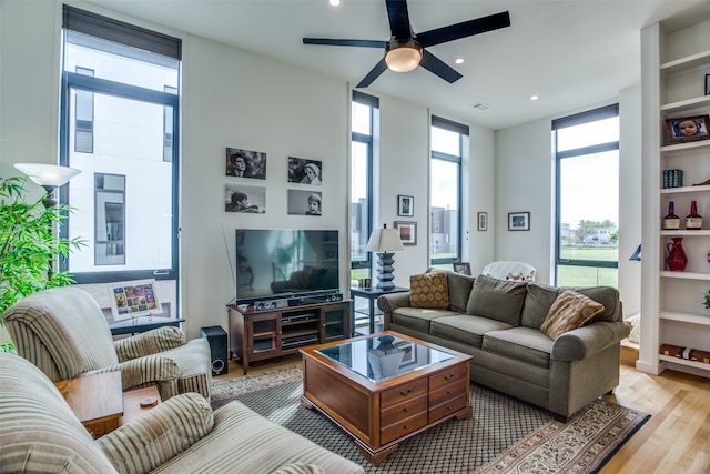 living area with light wood-style floors, recessed lighting, a ceiling fan, and floor to ceiling windows