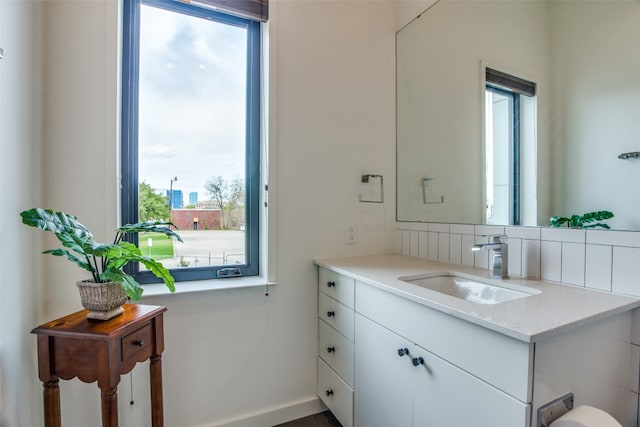 bathroom featuring vanity and decorative backsplash