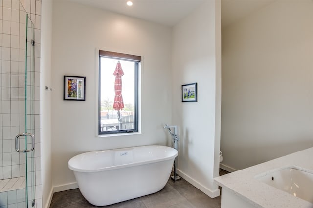 bathroom featuring a soaking tub, a shower stall, toilet, and baseboards