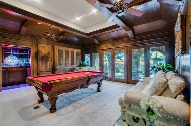 playroom featuring carpet floors, french doors, wooden walls, coffered ceiling, and beamed ceiling