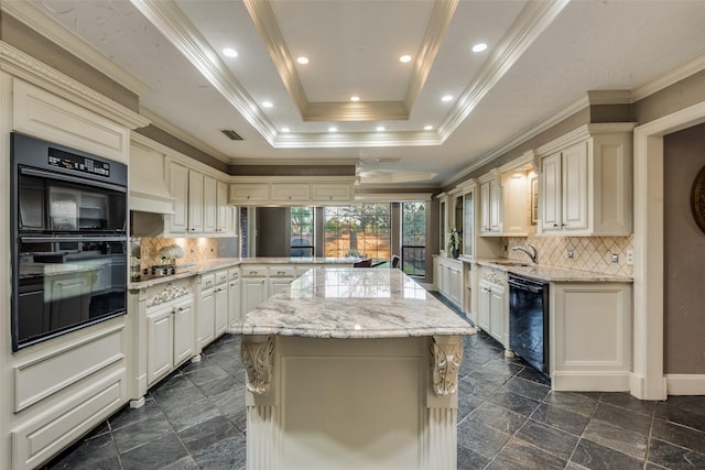 kitchen featuring a center island, kitchen peninsula, a tray ceiling, black appliances, and ornamental molding