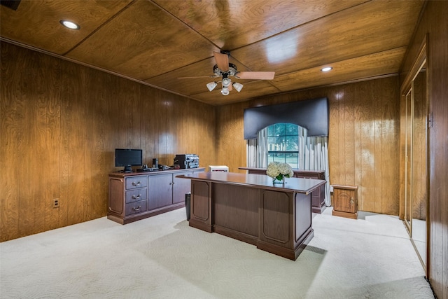 office space with light carpet, wood ceiling, and wooden walls