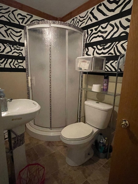 bathroom with an enclosed shower, toilet, and tile floors